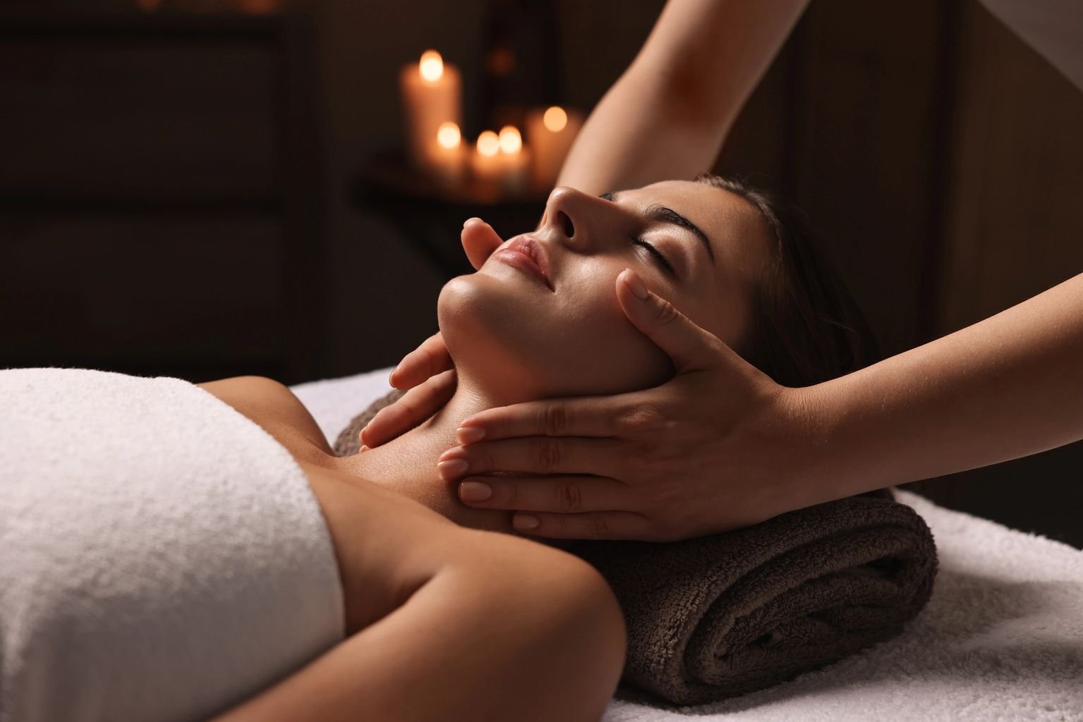 Attractive woman enjoying face massage, closeup